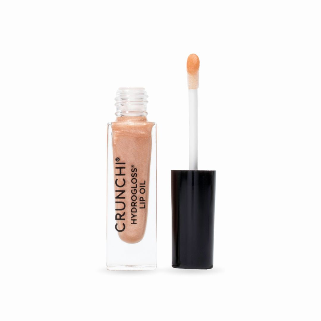 Lip oil with applicator on a white background