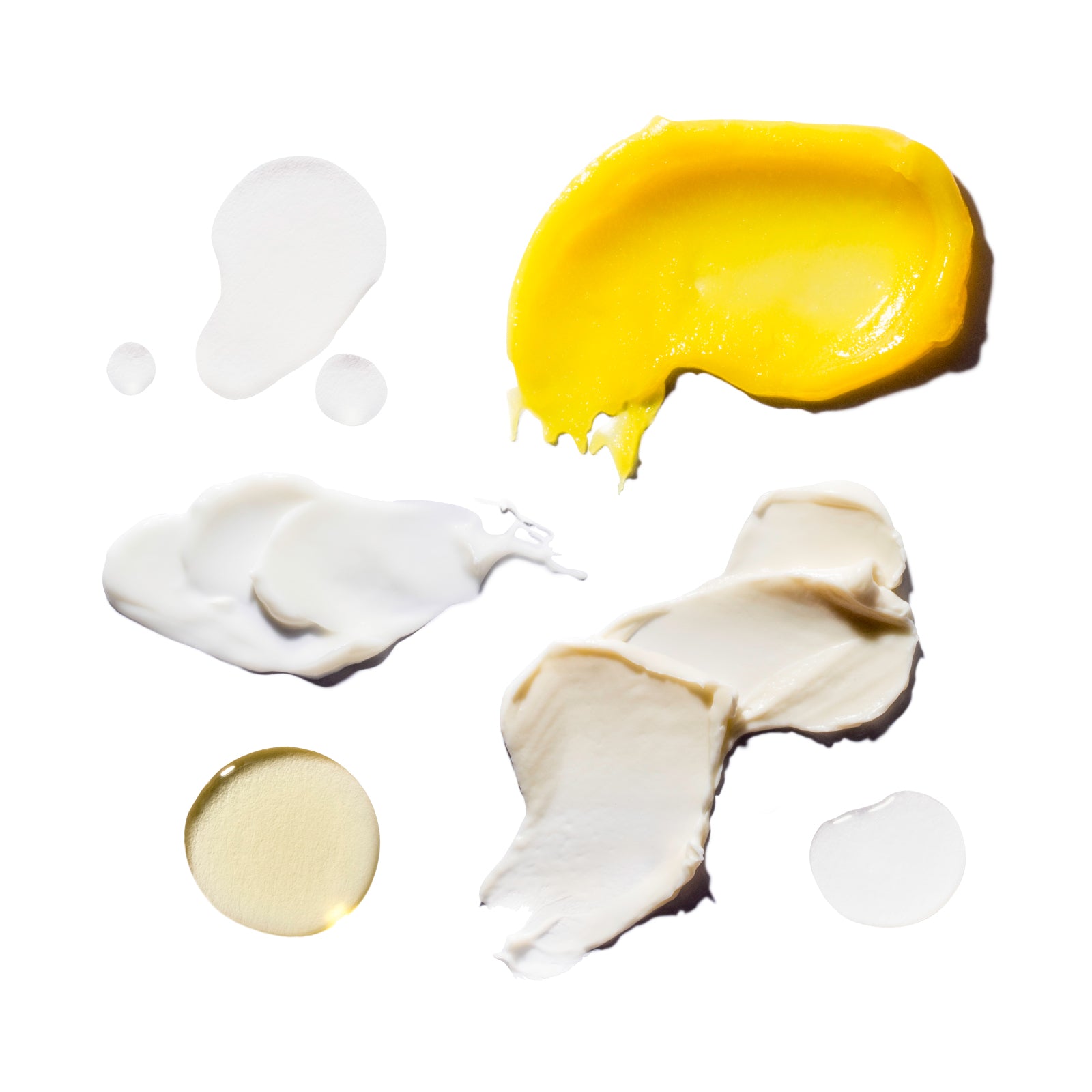 Yellow and white cosmetic products on a white background
