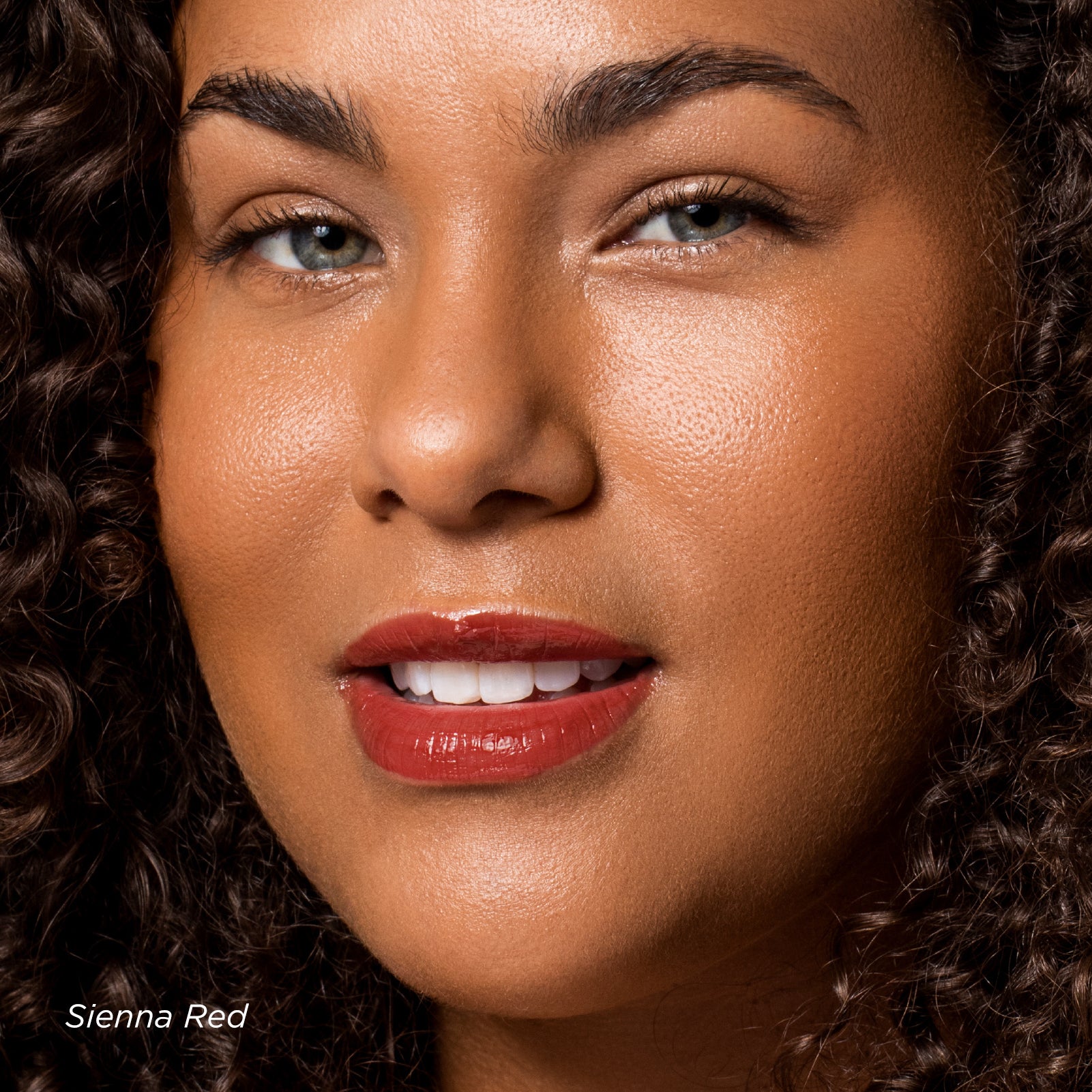 Close-up of a woman's face with a textured brown background