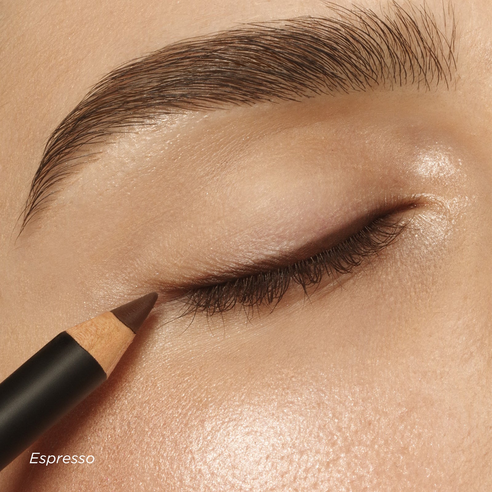 Eyebrow pencil being used on a person's eyebrow with 'Espresso' color swatch.