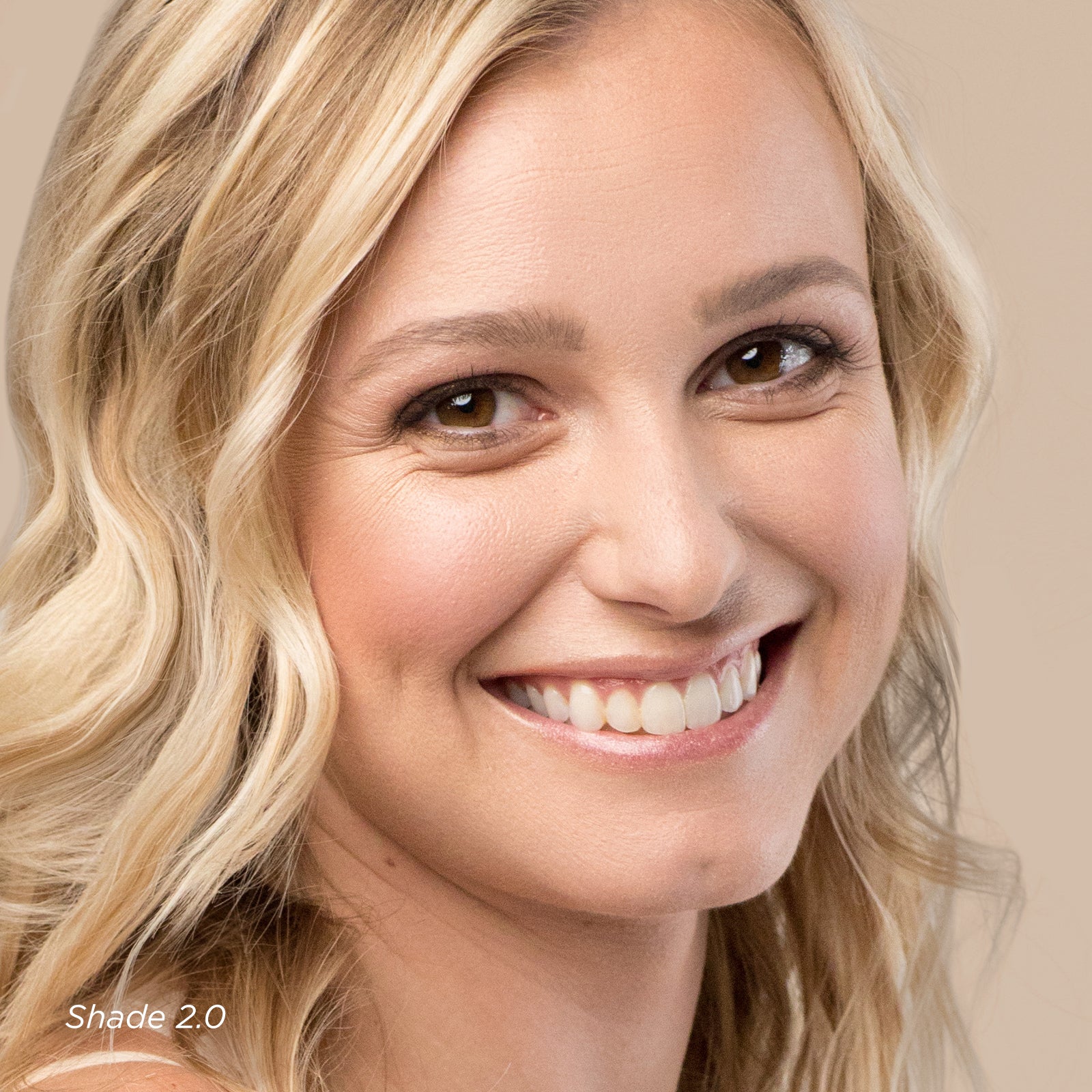 Close-up of a woman with blonde hair and a neutral background