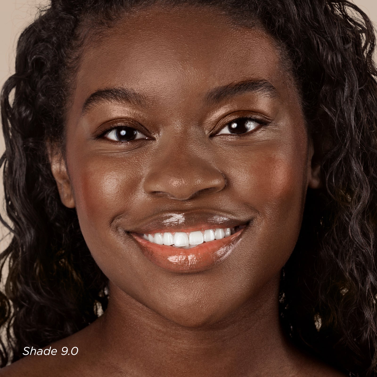 Woman with a warm smile against a neutral background