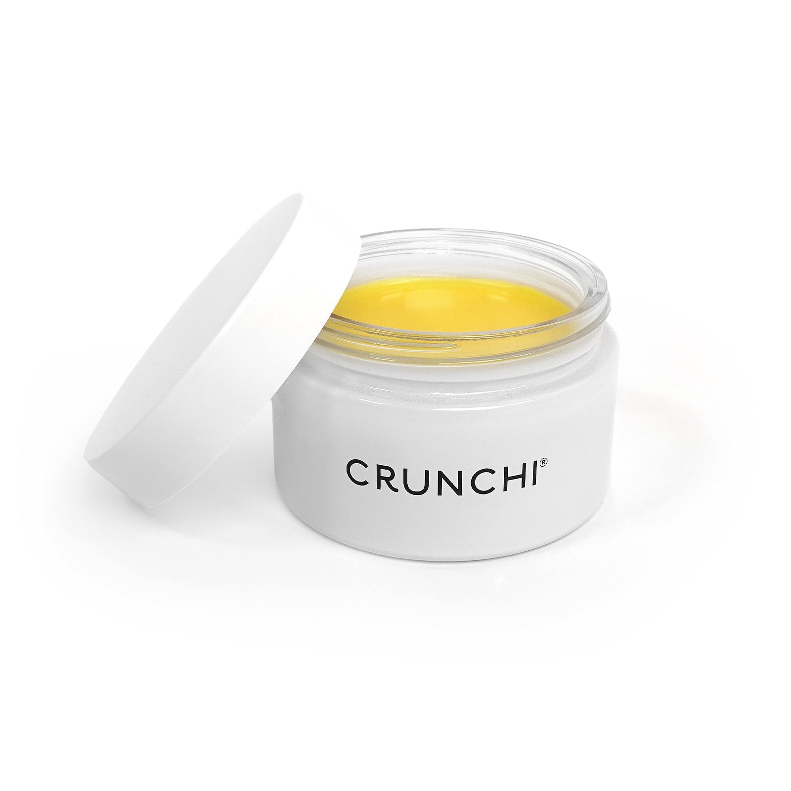 Jar of yellow cream with a white lid on a white background, branded 'CRUNCHI'.