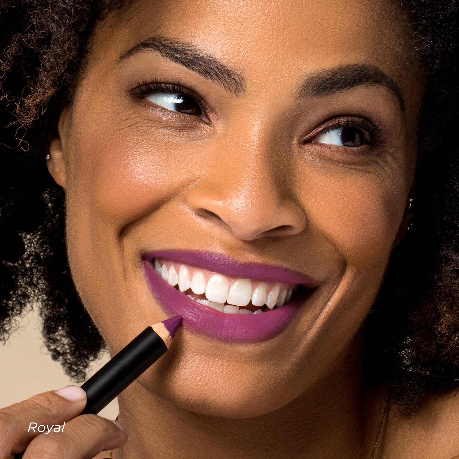 Woman applying purple lipstick with a focus on her face.