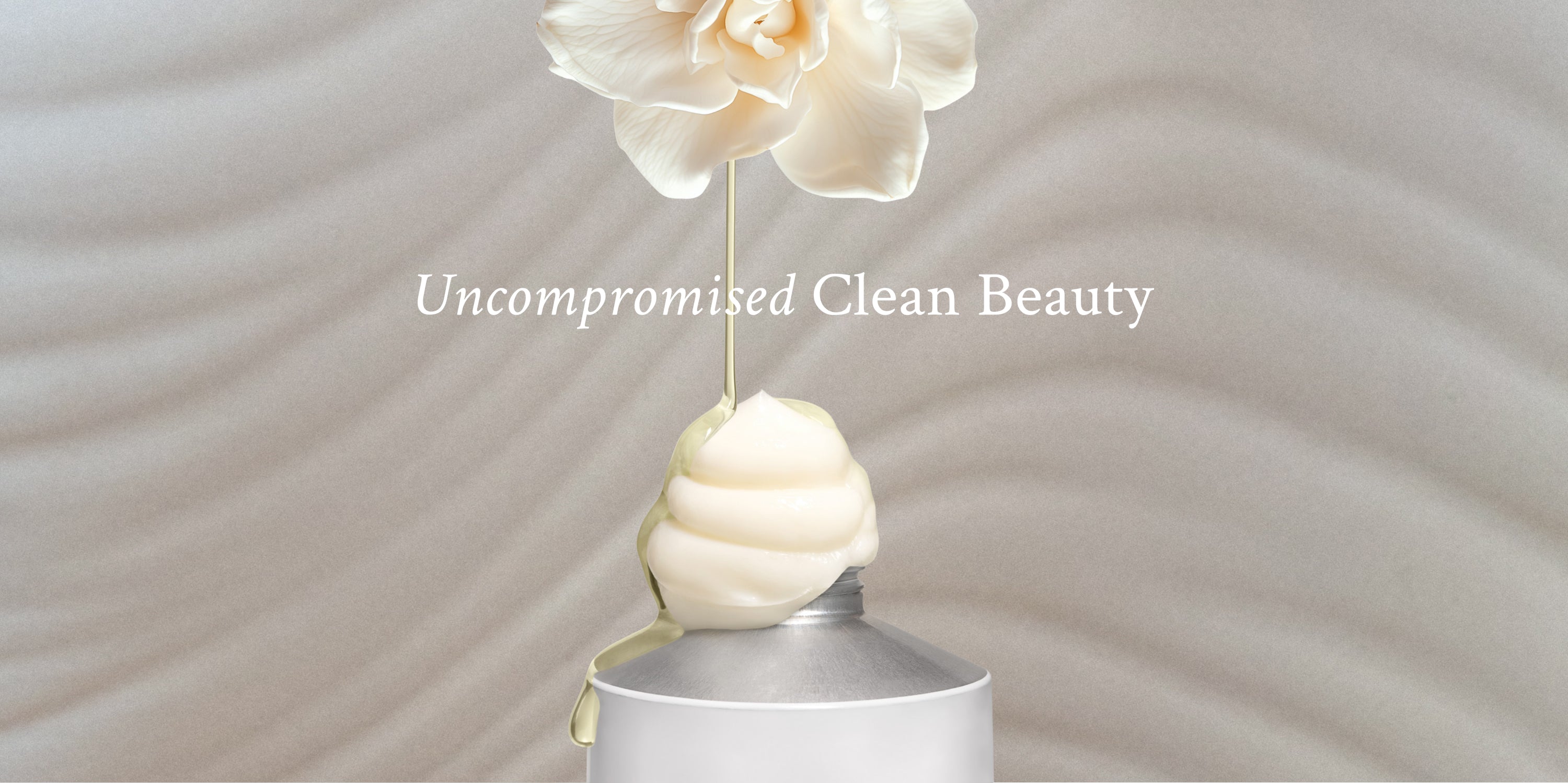 Cosmetic product with a flower on a wavy beige background, featuring the text 'Uncompromised Clean Beauty'.